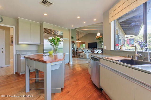 a kitchen with counter top space and windows