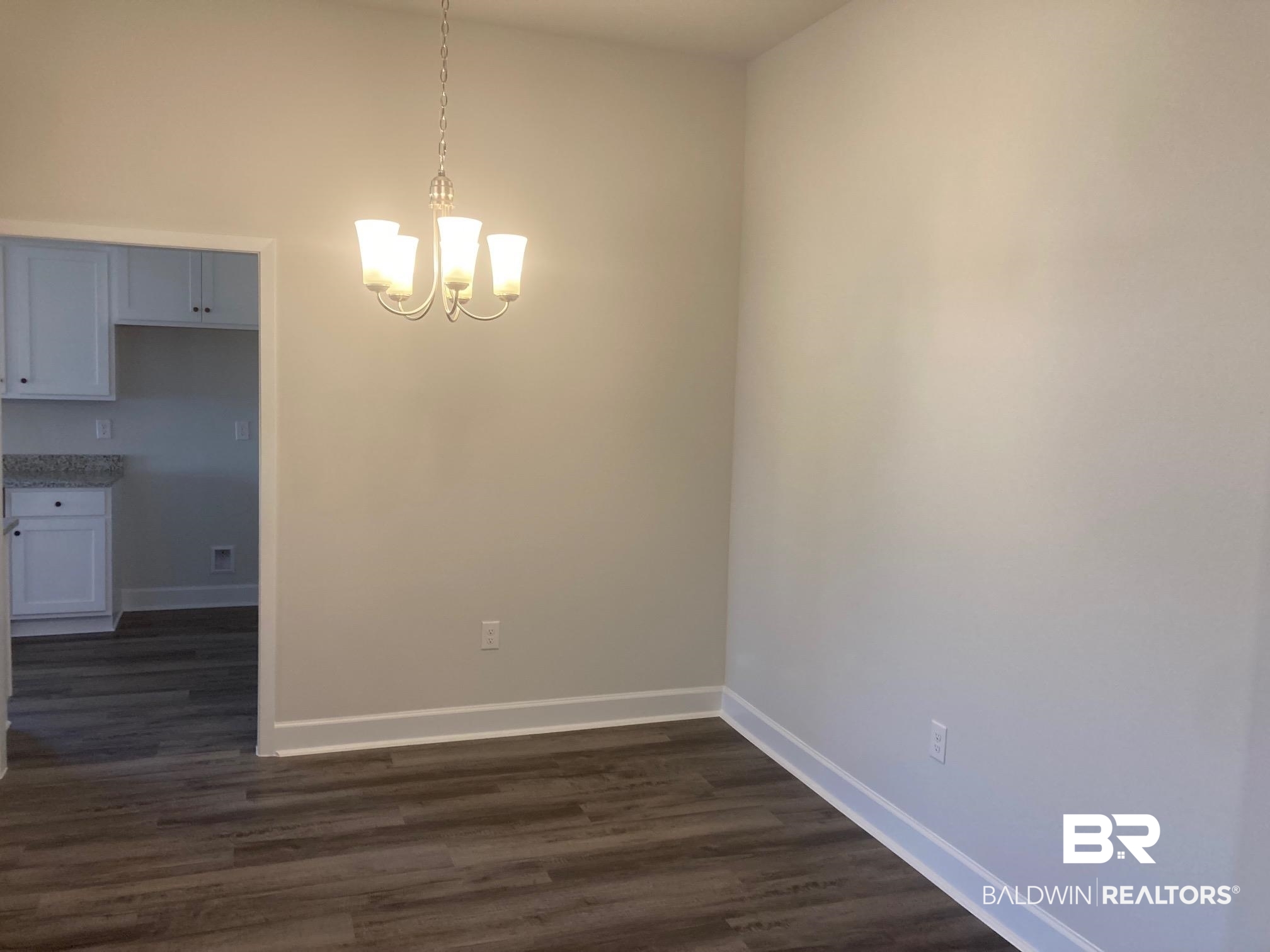 629 Revere Street Foley, AL 36535 - Photo 8 of 30 Unfurnished dining area with dark wood-type flooring and a notable chandelier
