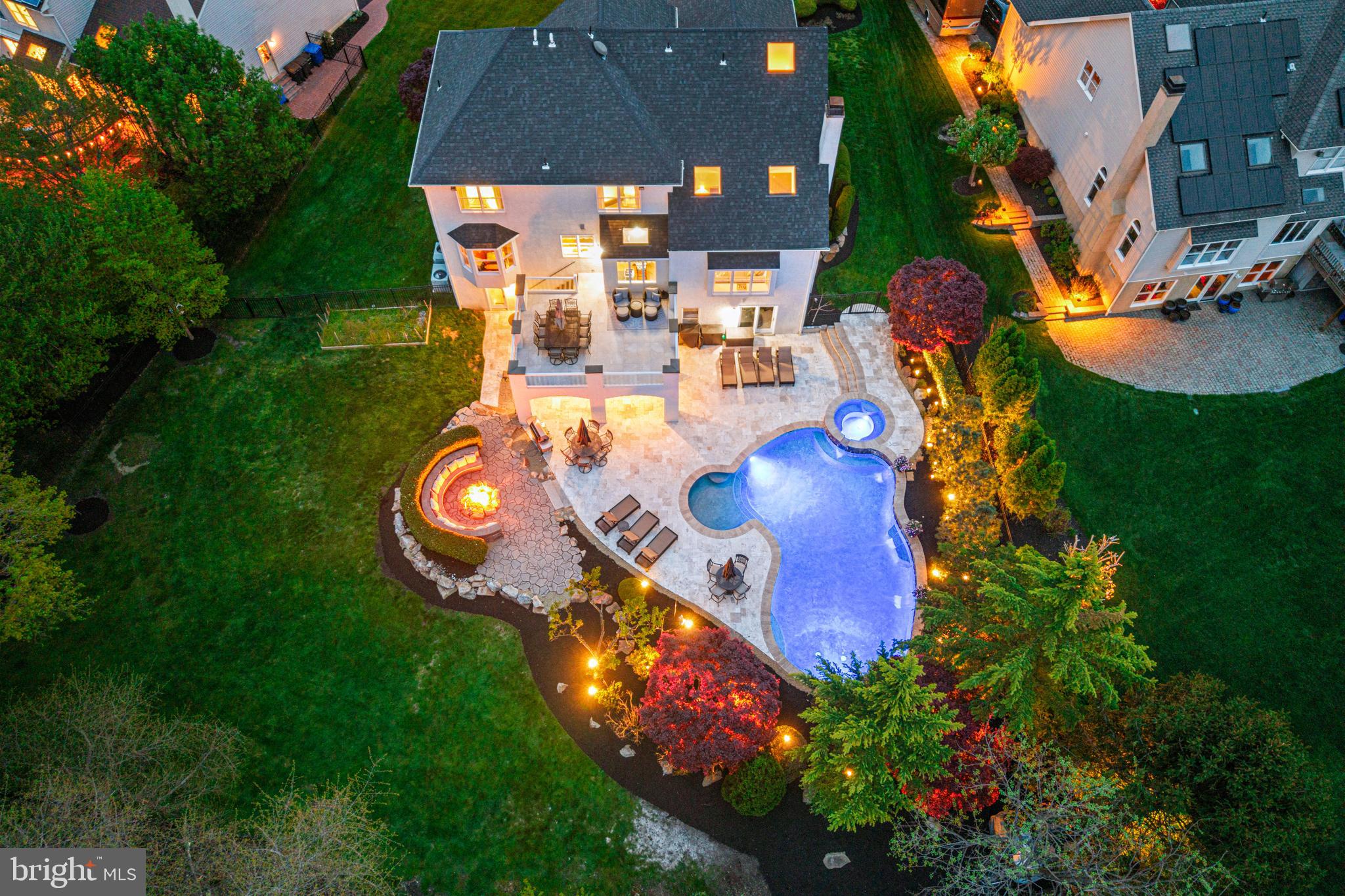 an aerial view of a house with outdoor space pool seating area and yard