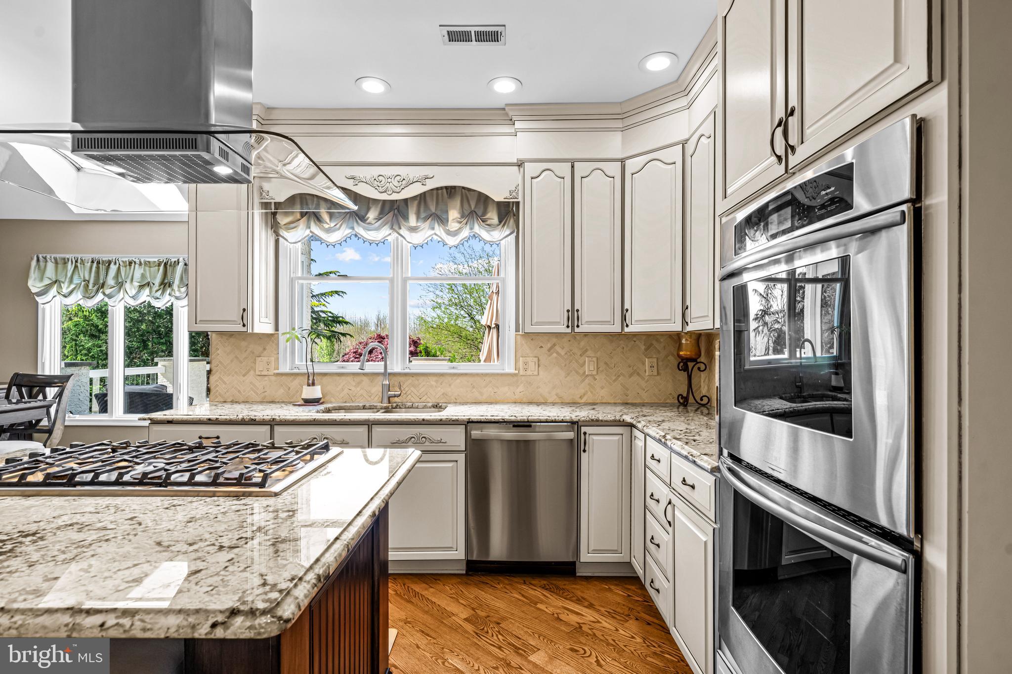 61 Brooks Road Moorestown, NJ 08057 - Photo 56 of 93 a kitchen with stainless steel appliances granite countertop a sink stove and refrigerator