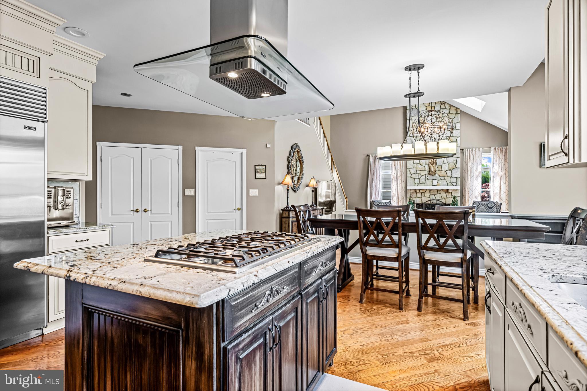 61 Brooks Road Moorestown, NJ 08057 - Photo 61 of 93 a open kitchen with stainless steel appliances granite countertop a stove a refrigerator a kitchen island a dining table and chairs with wooden floor