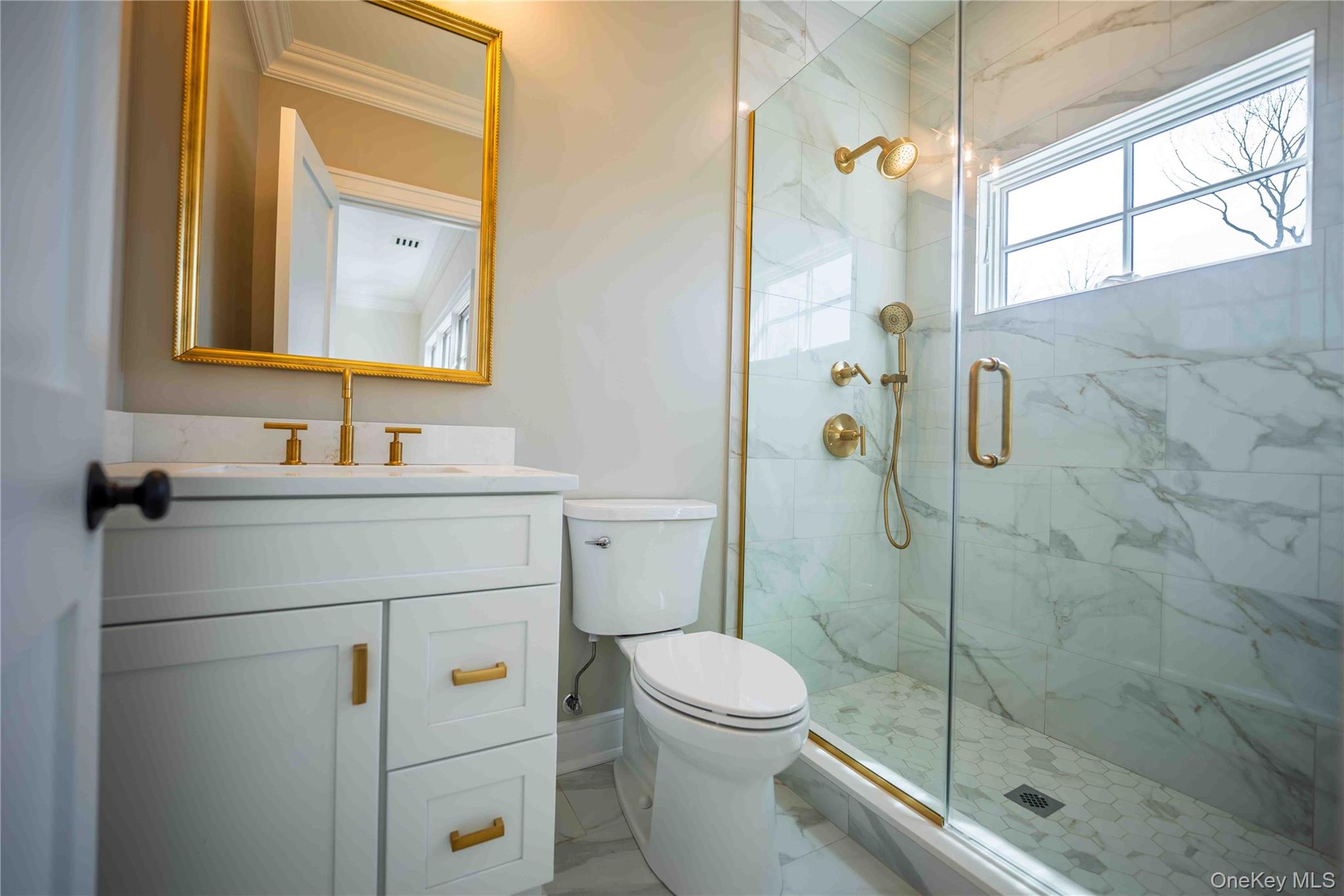 106 Cove Road Asharoken, NY 11768 - Photo 30 of 46 Full bathroom featuring vanity, a marble finish shower, and ornamental molding