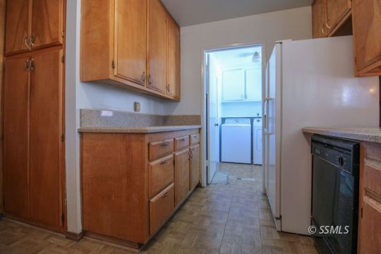 537 South Fairview Street Ridgecrest, CA 93555 - Photo 12 of 35 a kitchen with a refrigerator and cabinets