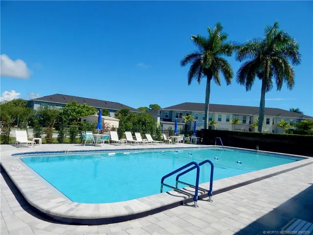 a view of a swimming pool with a table and chairs