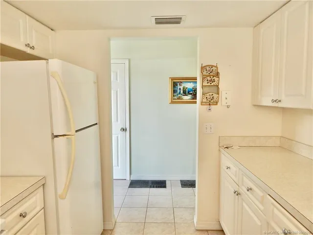a living room with furniture chandelier and a window