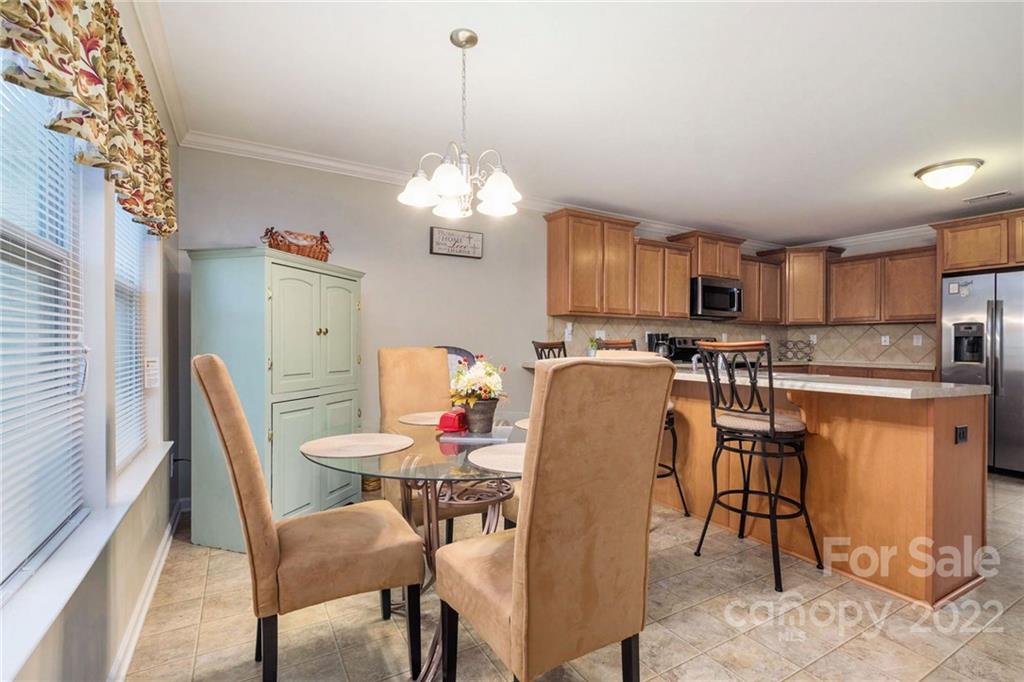 5846 Ringneck Road Charlotte, NC 28216 - Photo 12 of 28 a view of a dining room with furniture and chandelier