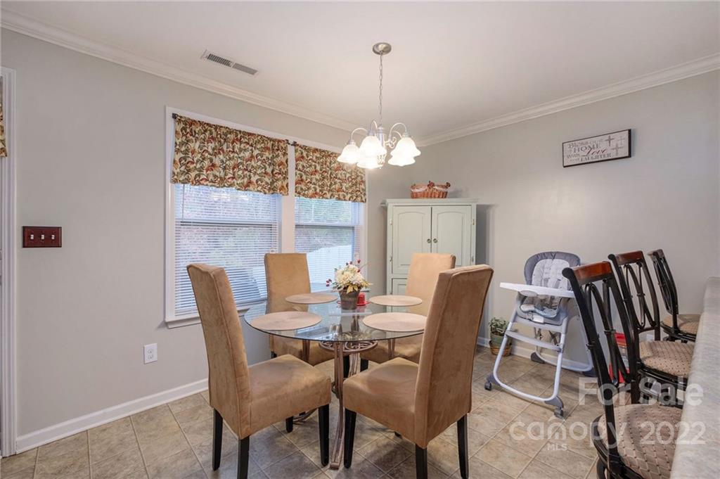 5846 Ringneck Road Charlotte, NC 28216 - Photo 13 of 28 a dining room with furniture a chandelier and window