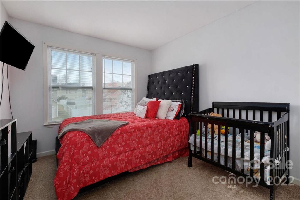 5846 Ringneck Road Charlotte, NC 28216 - Photo 23 of 28 a bedroom with a bed and a window
