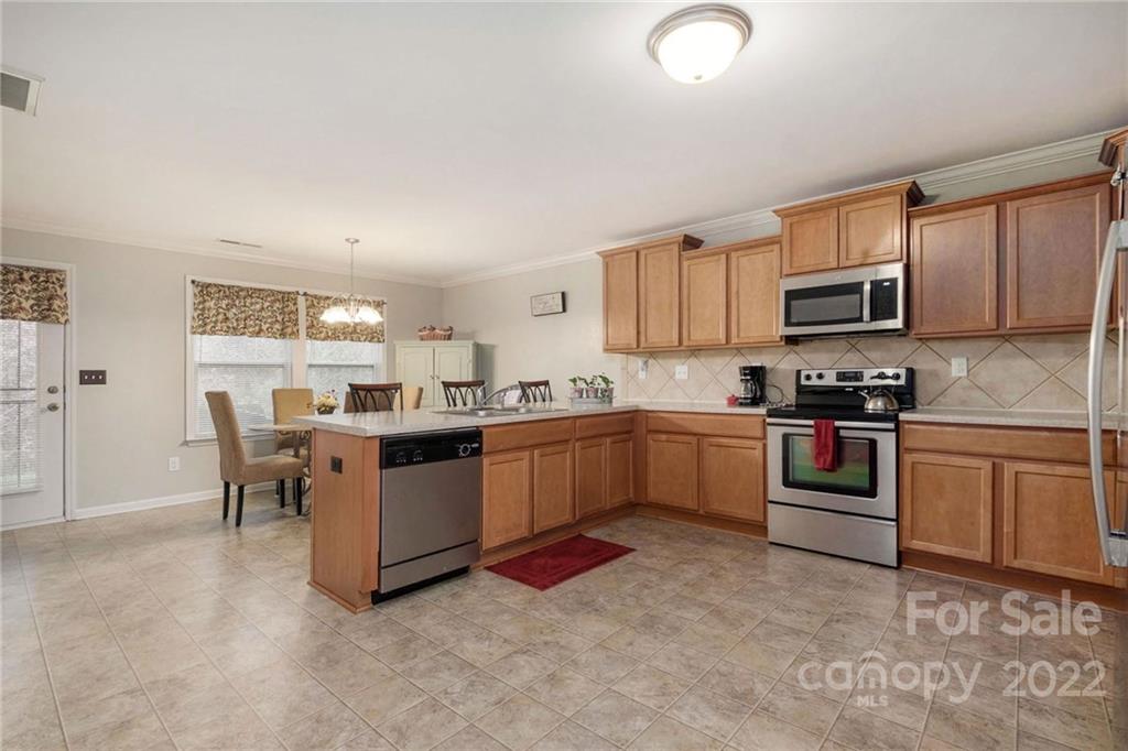 5846 Ringneck Road Charlotte, NC 28216 - Photo 8 of 28 a kitchen with a sink cabinets and stainless steel appliances