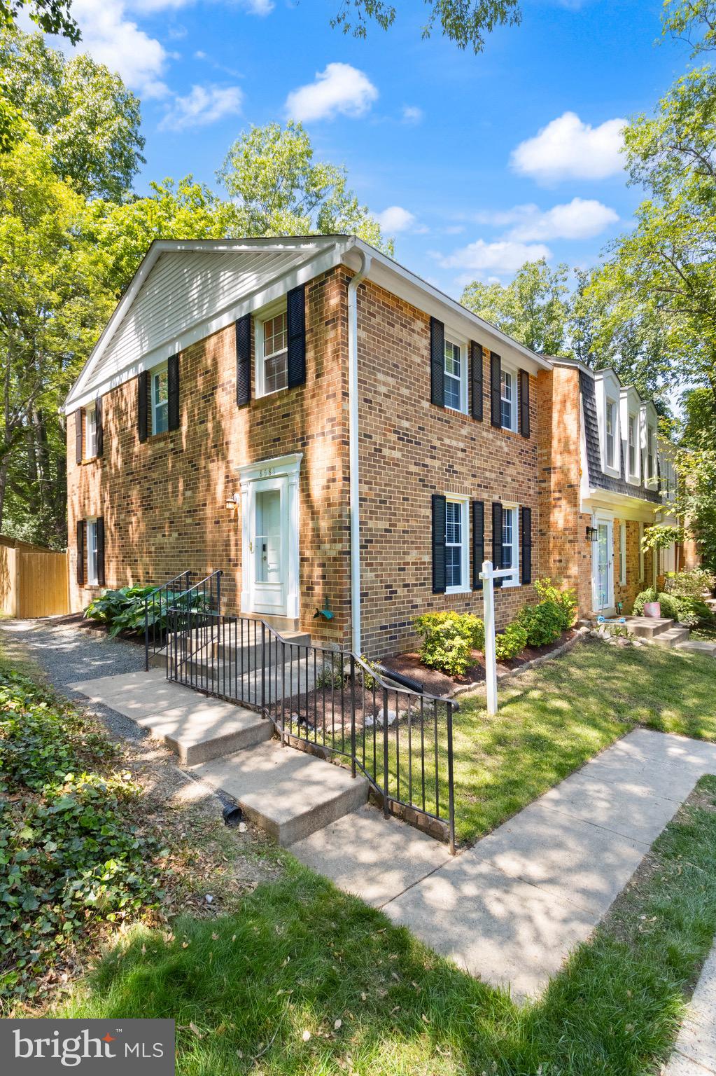 8581 Chester Grove Court Springfield, VA 22153 - Photo 38 of 38 a view of a brick house with a yard