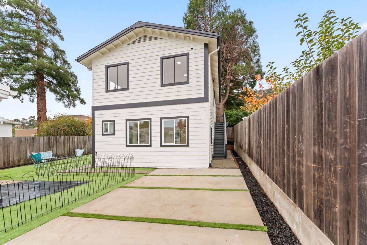 339 Monterey Street Brisbane, CA 94005 - Photo 23 of 30 a front view of a house with a garden and plants