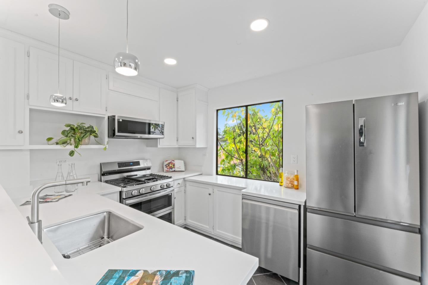 339 Monterey Street Brisbane, CA 94005 - Photo 6 of 30 a kitchen with stainless steel appliances a refrigerator sink and stove