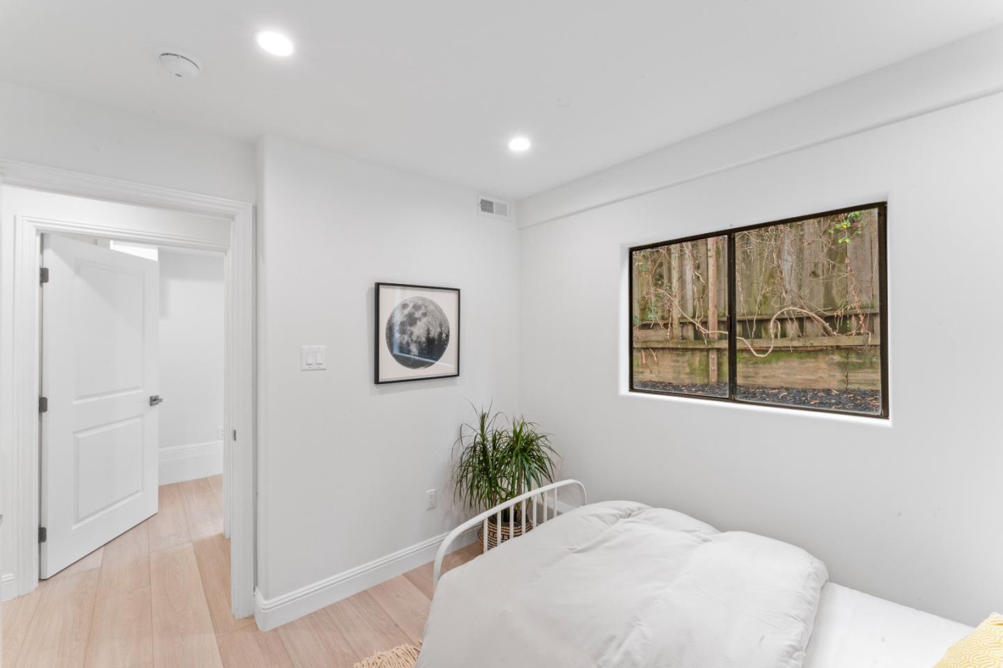 339 Monterey Street Brisbane, CA 94005 - Photo 10 of 30 a bedroom with a bed and a painting on the wall