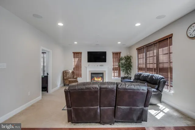 a kitchen with stainless steel appliances kitchen island granite countertop wooden floors and wooden cabinets