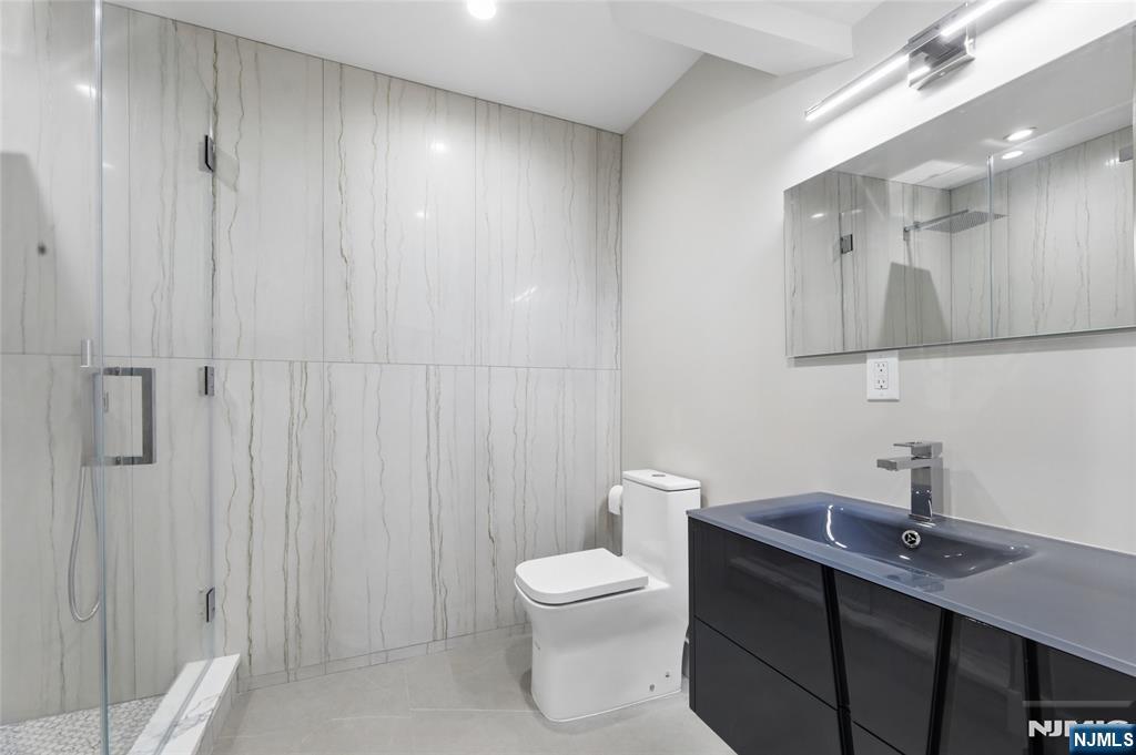 31 Engleside Street Cresskill, NJ 07626 - Photo 38 of 49 a bathroom with a toilet a sink and mirror