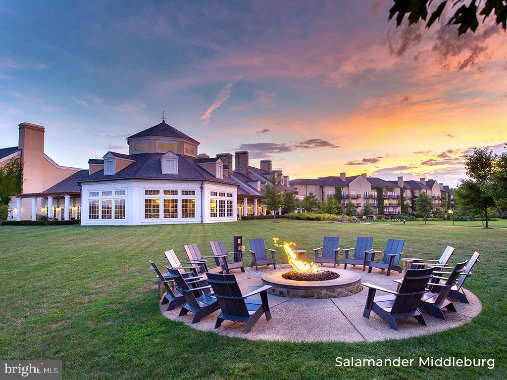 400 Martingale Ridge Drive Middleburg, VA 20117 - Photo 18 of 21 a view of a lake with a lounge chairs and a table