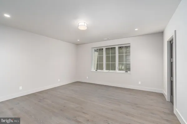 an empty room with windows and closet