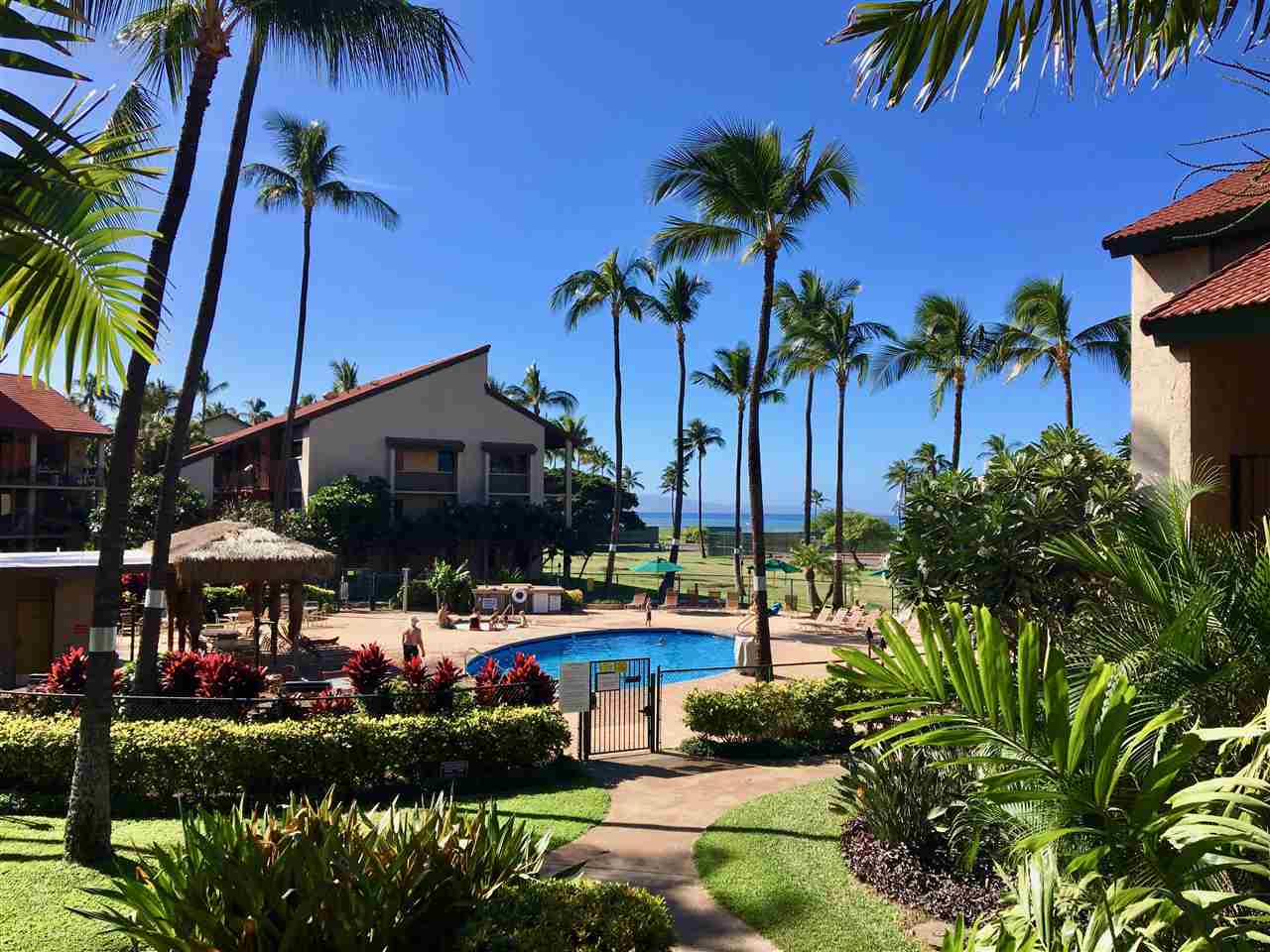 940 South Kihei Road, Unit B212 Kihei, HI 96753 - Photo 21 of 22 a view of an chairs and table in patio with a table and chairs under an umbrella