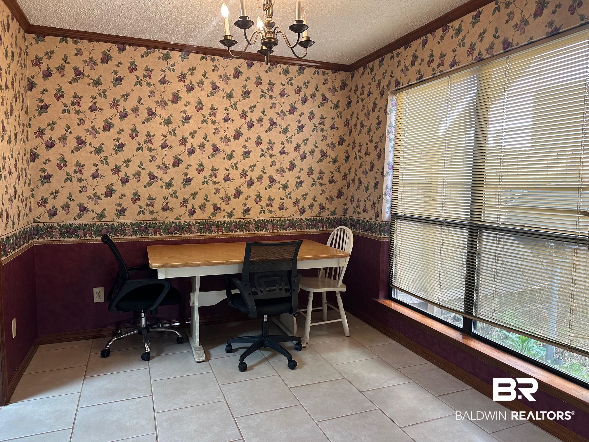 6533 Cedar Bend Court, Unit A Mobile, AL 36608 - Photo 11 of 16 Office with wallpapered walls, a textured ceiling, a wainscoted wall, crown molding, and a chandelier