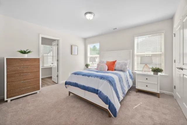 a spacious bedroom with a bed and a window