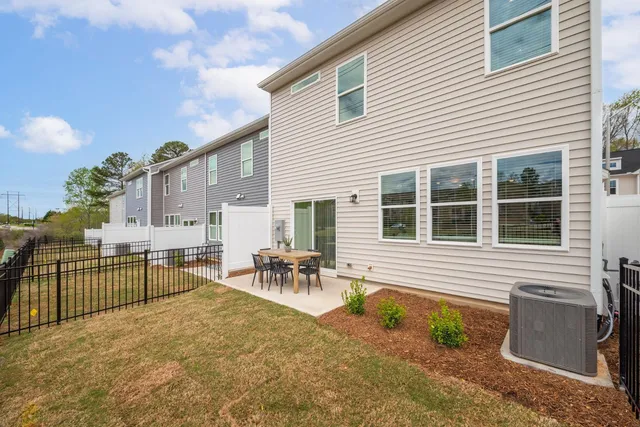 a backyard of a house with table and chairs
