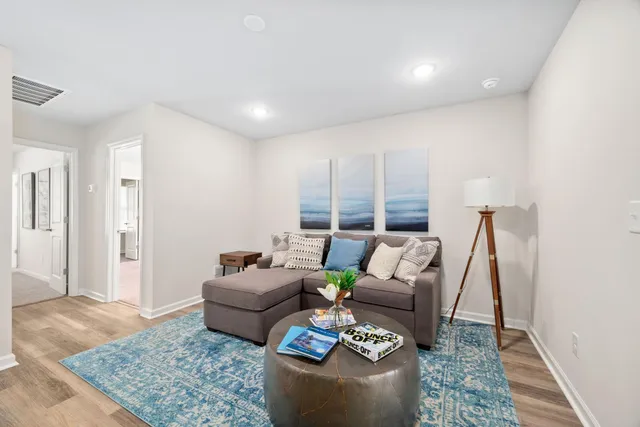 a living room with furniture and a rug