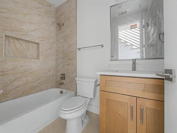 a bathroom with a sink toilet and shower