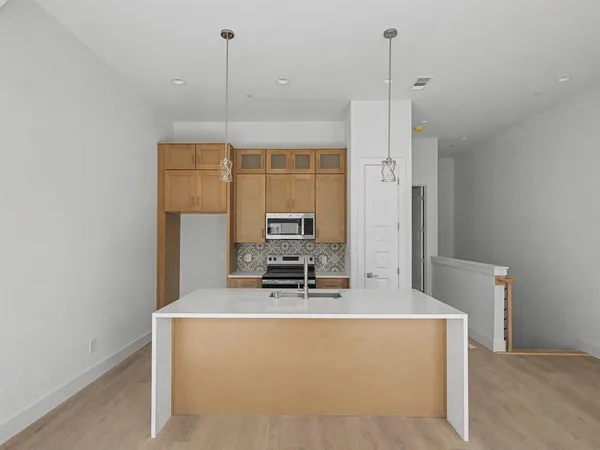 a room with furniture a flat screen tv and a window