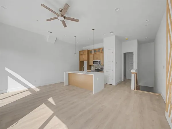 a view of a room with cabinet and a ceiling fan
