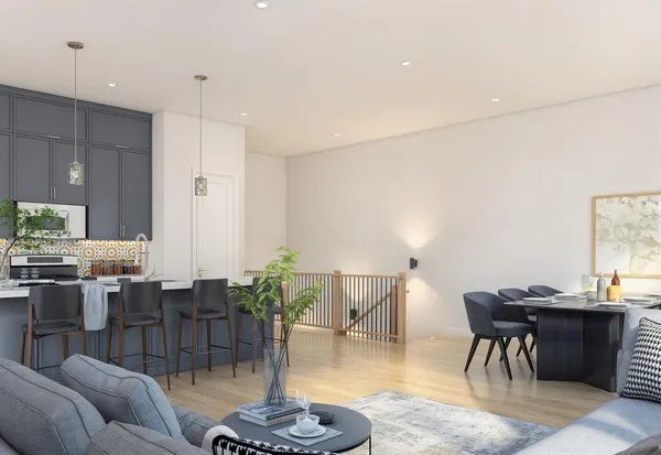 a living room with lots of furniture and kitchen view