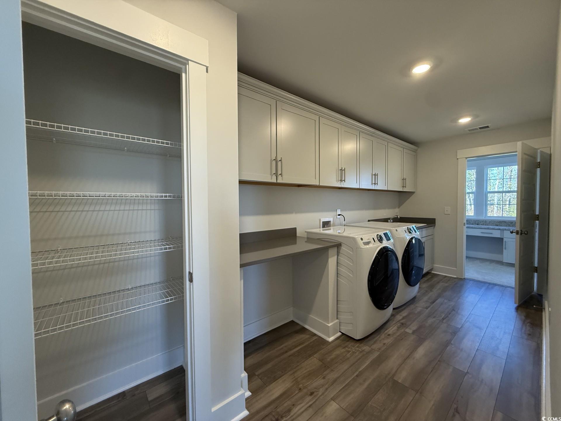 3220 Visionary Drive Myrtle Beach, SC 29588 - Photo 15 of 33 Laundry area featuring washing machine and dryer, dark wood finished floors, cabinet space, and recessed lighting