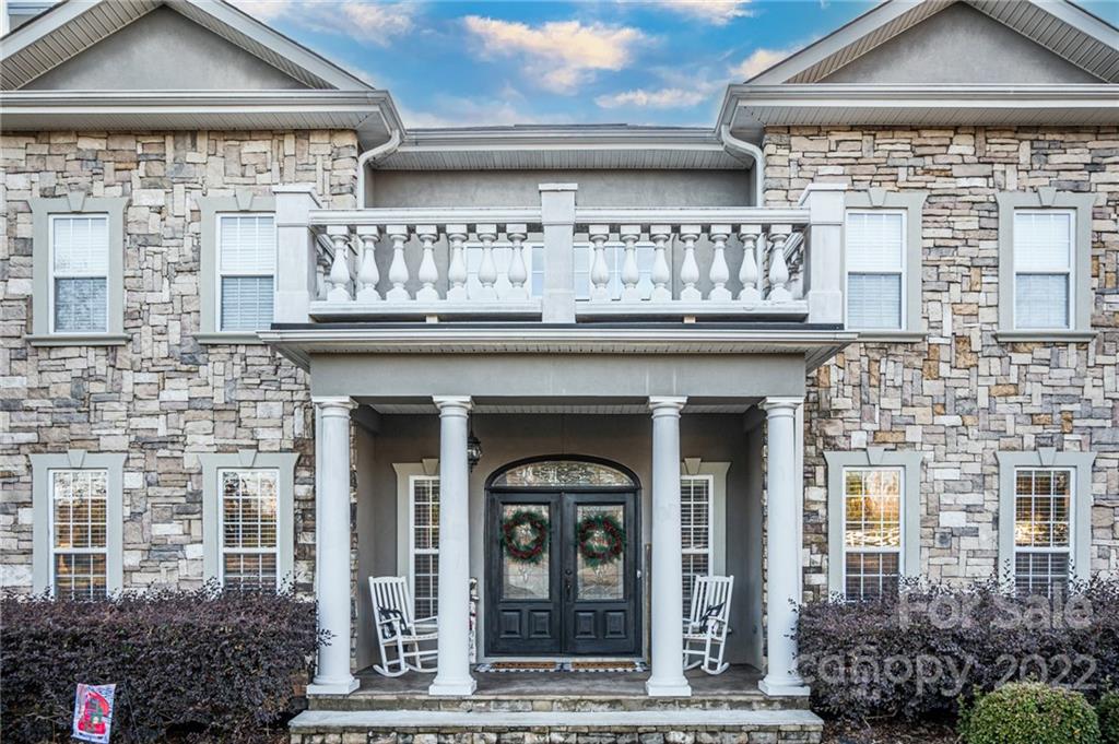 a front view of a building with a garden