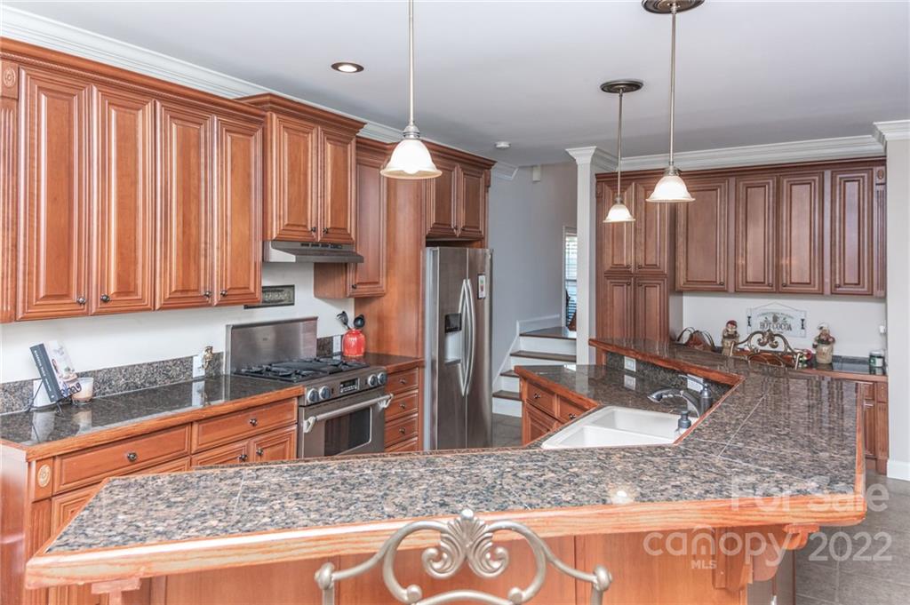 137 Birtwick Road Rockwell, NC 28138 - Photo 12 of 42 a kitchen with stainless steel appliances granite countertop a sink a stove counter space and cabinets