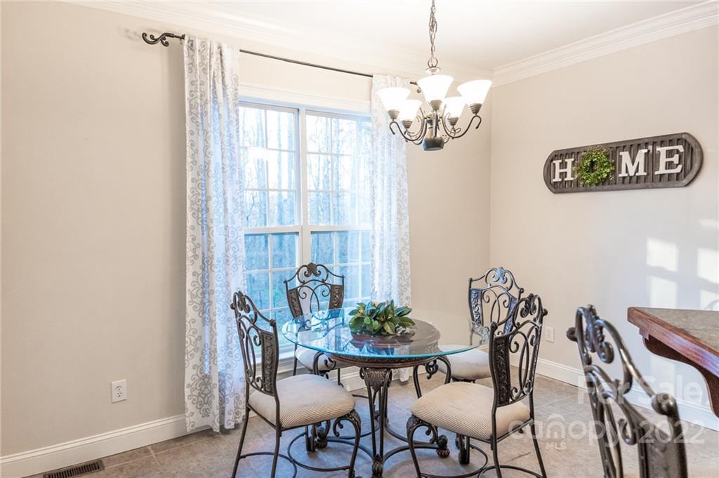 137 Birtwick Road Rockwell, NC 28138 - Photo 14 of 42 a view of a dining room with furniture wooden floor and a chandelier