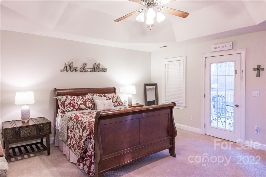 137 Birtwick Road Rockwell, NC 28138 - Photo 23 of 42 a bedroom with a bed and a chandelier