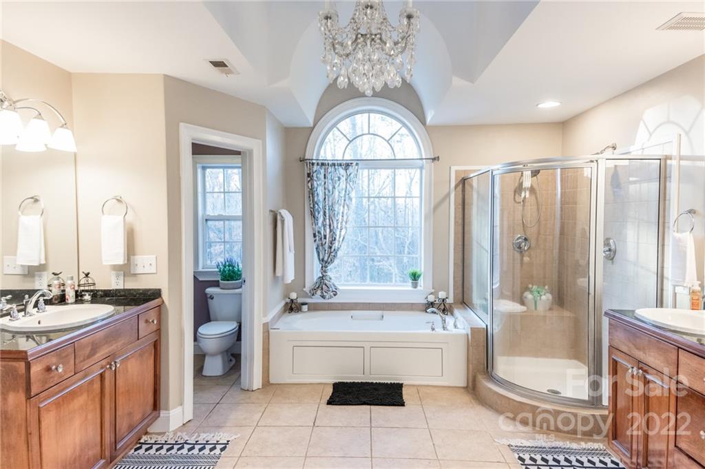 137 Birtwick Road Rockwell, NC 28138 - Photo 24 of 42 a spacious bathroom with a double vanity sink a mirror a bathtub and next to a window