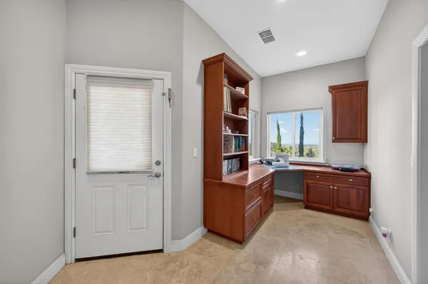 a view of a workspace with furniture and a flat screen tv