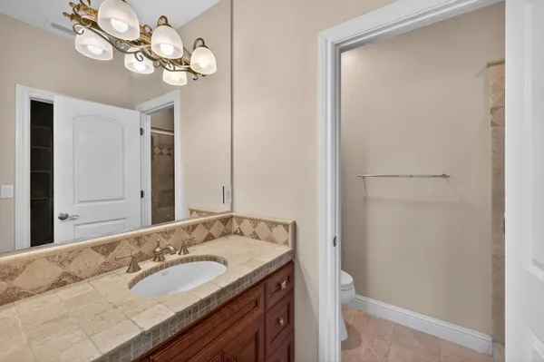 a front view of a house with garden and swimming pool