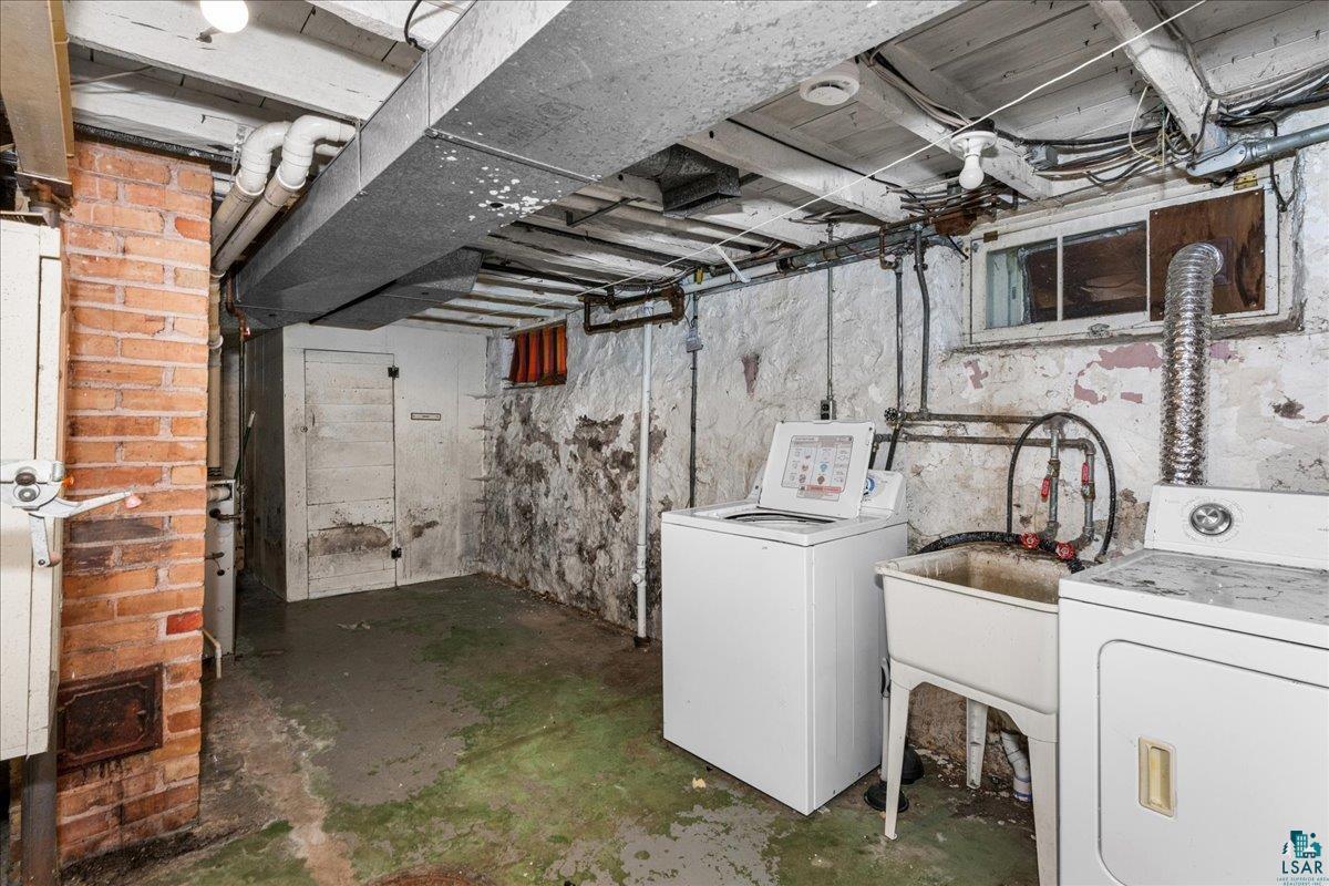 424 East Upham Road Duluth, MN 55811 - Photo 18 of 38 Laundry area featuring a utility sink with a faucet, exposed brick column, and a small window
