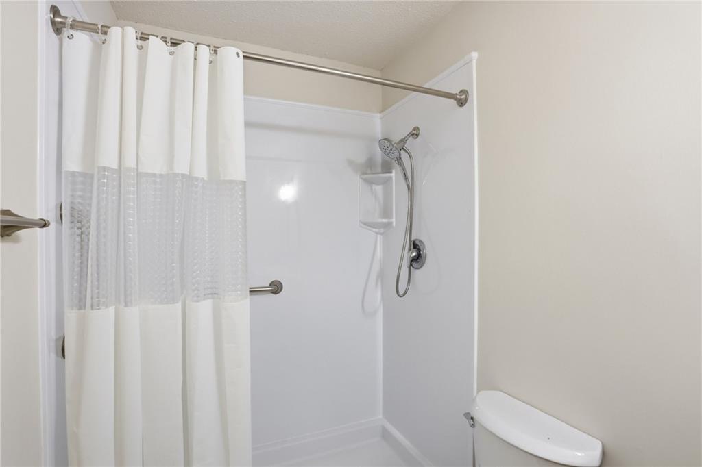 413 Promenade Court Marietta, GA 30064 - Photo 22 of 28 a bathroom with a shower and toilet