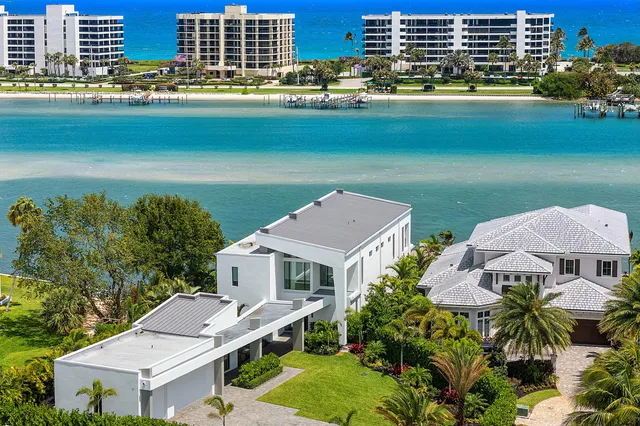 a aerial view of a house with a garden and lake view