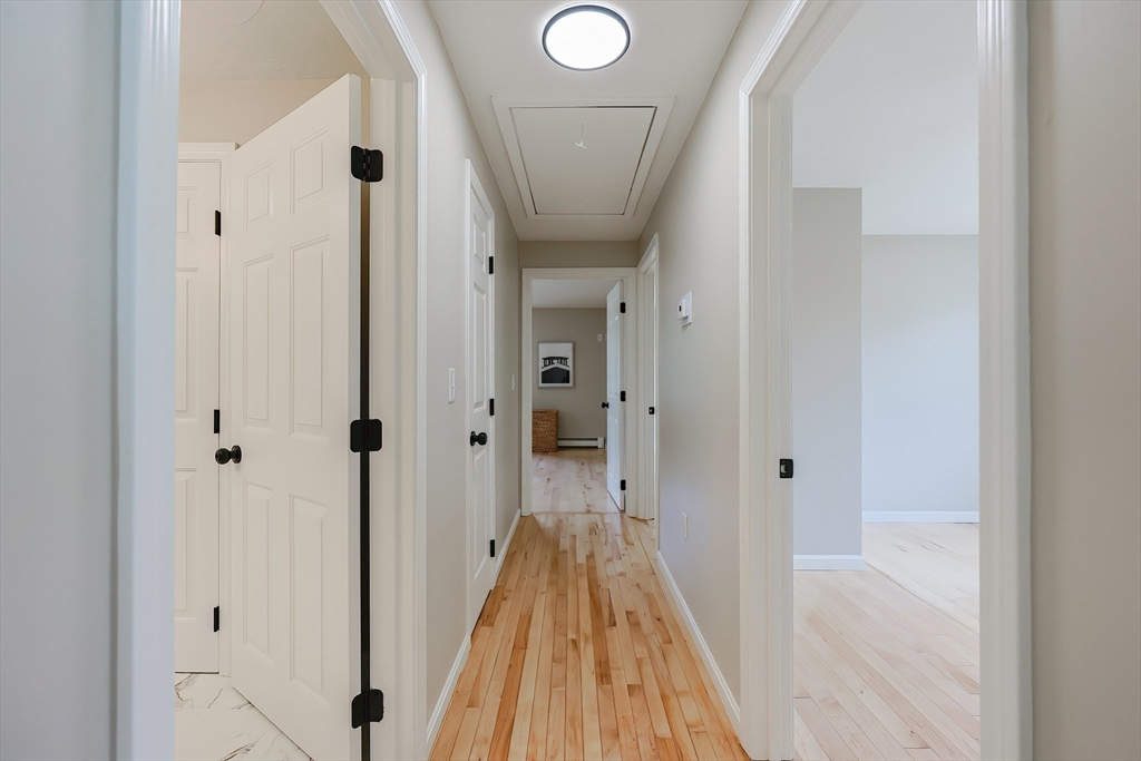 5 East Public Street Freetown, MA 02702 - Photo 25 of 41 a view of a hallway with wooden floor and a bathroom