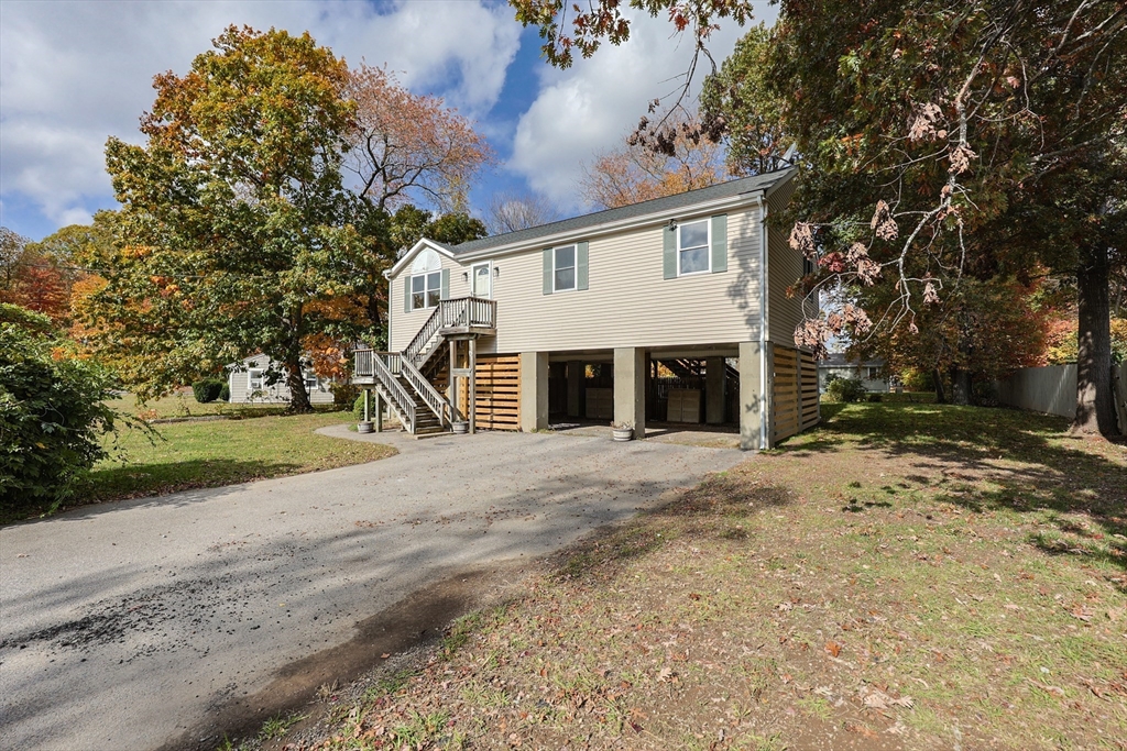 5 East Public Street Freetown, MA 02702 - Photo 3 of 41 a view of a house with a yard and garage