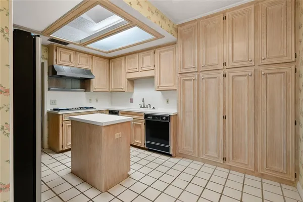 a kitchen with stainless steel appliances a sink stove and refrigerator