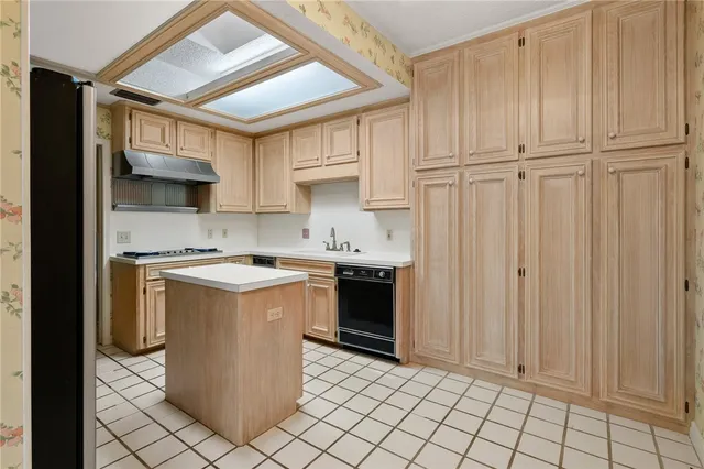 a kitchen with stainless steel appliances a sink stove and refrigerator