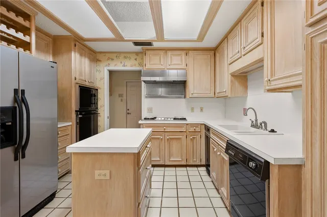 a kitchen with a cabinets and a refrigerator