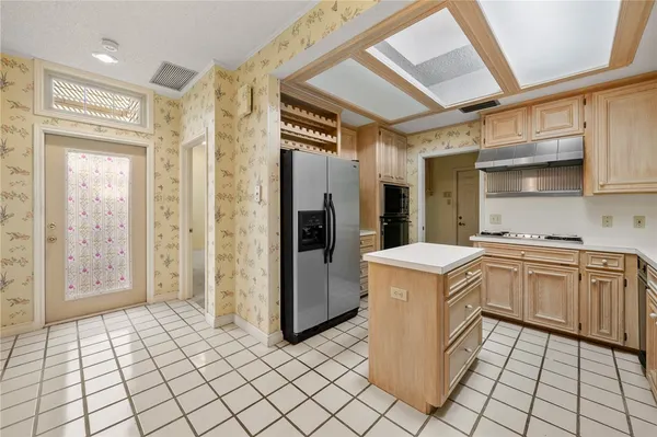 a kitchen with stainless steel appliances a refrigerator and a stove
