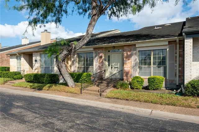 a front view of a house with garden