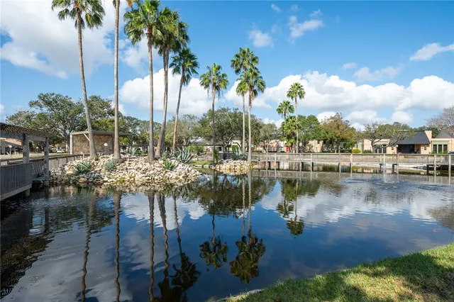 a view of swimming pool with trees and a lake view
