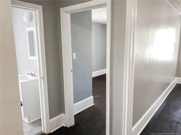 a view of a hallway with wooden floor